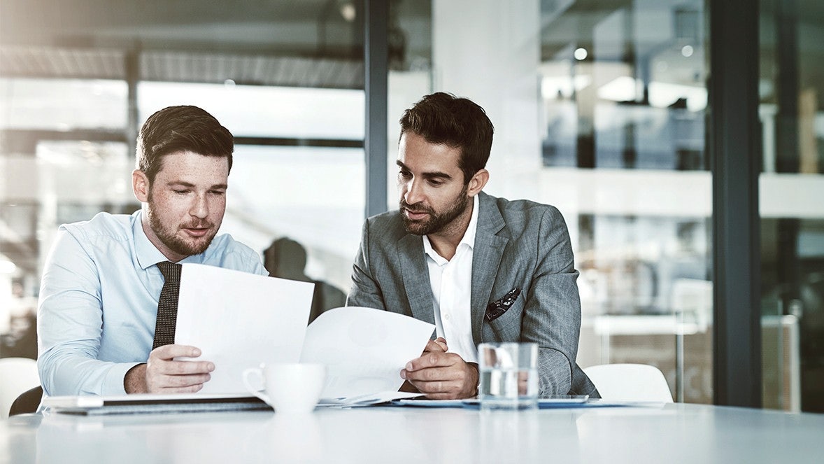 men looking to papers
