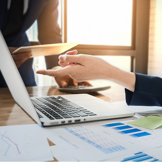 hand pointing at a laptop