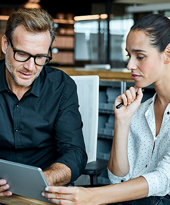 two colleagues looking at a tablet together