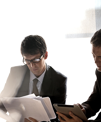 men looking into papers