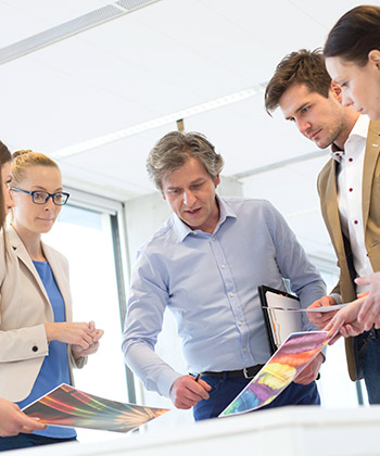 colleagues reviewing images in a meeting