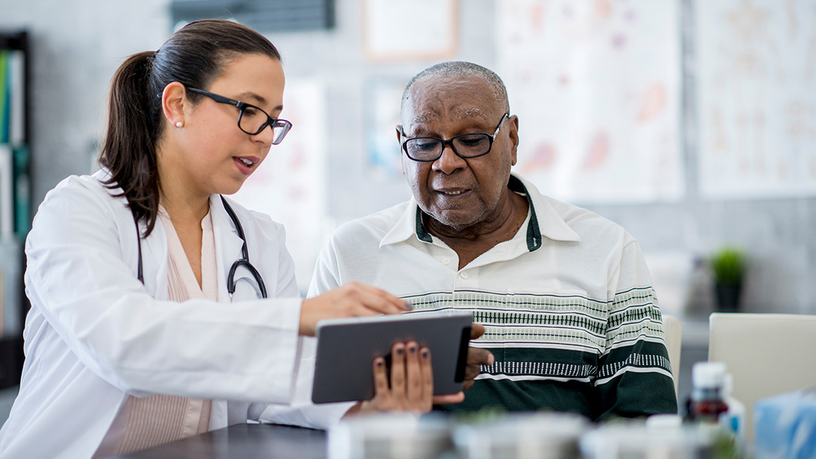 doctor showing patient information on a tablet