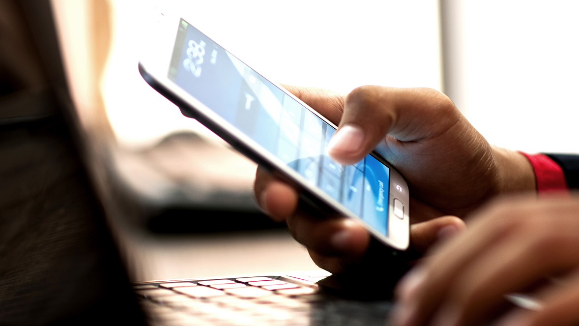 close up of hands using mobile phone