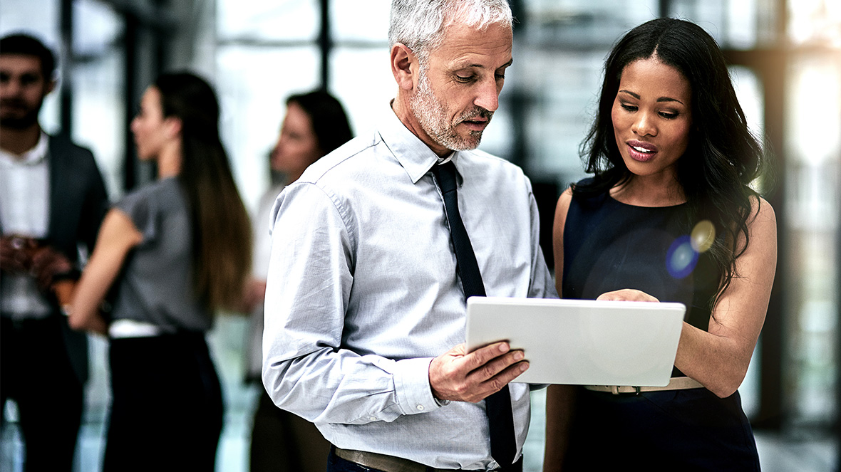 two colleagues looking at portable screen