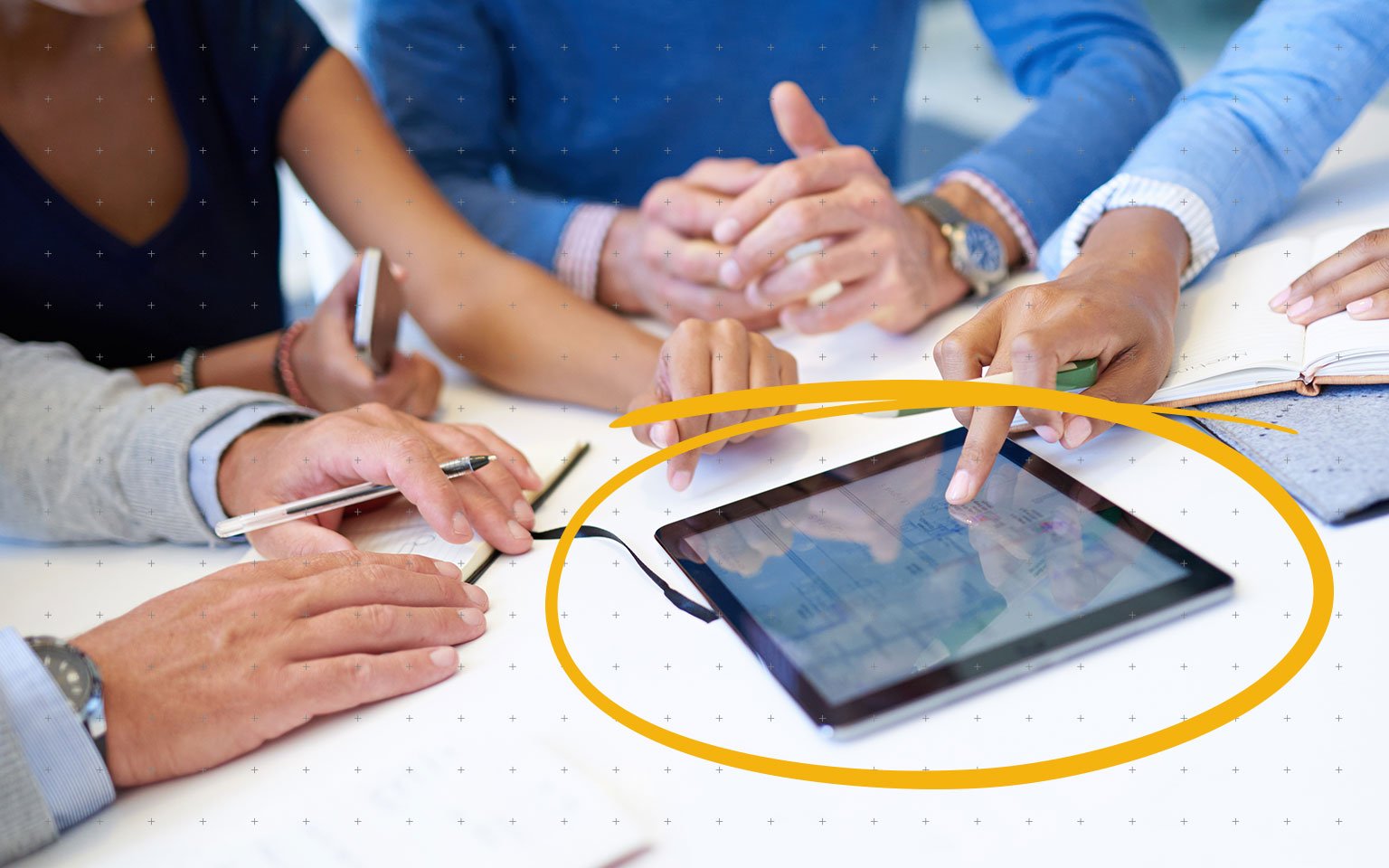 close up of colleagues using a tablet in a meeting