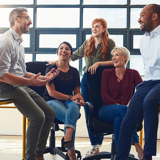 "Respecter la création et aider les Hommes" group of colleagues in a meeting