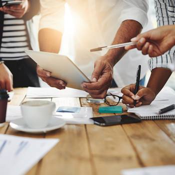 Visie close up of employees working on tablet