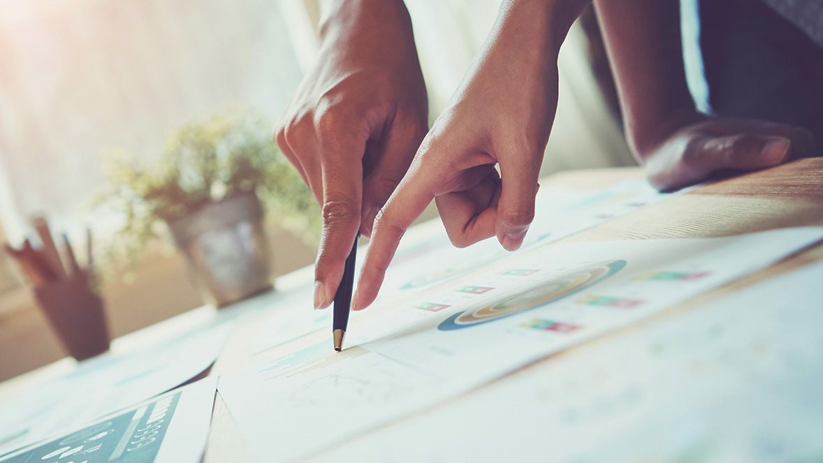 two hands pointing to a work document two hands pointing to a work document