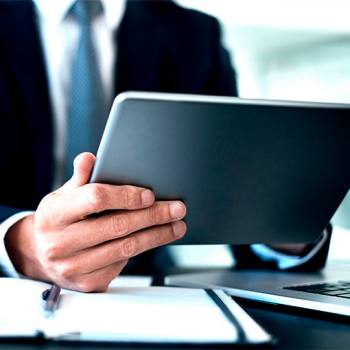 man typing in his tablet